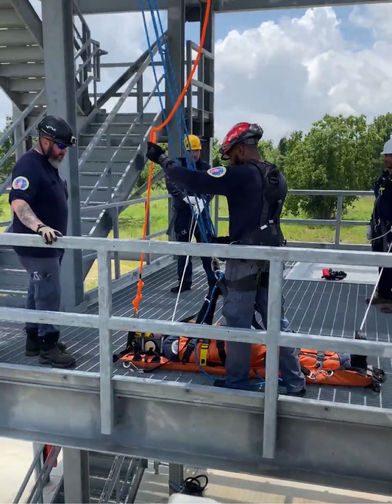 Raptor rescue technicians conducting a rope-rescue drill on an elevated industrial platform